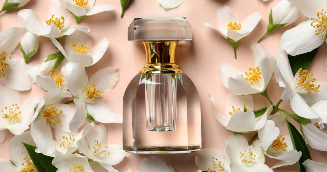 A bottle of perfume surrounded by white flower petals.