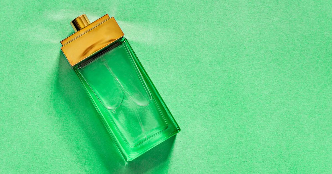 A bottle of patchouli perfume against a green background.